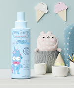 A Jack N' Jill Detangler & Leave-In Conditioner bottle on a shelf next to little cermaic pots.