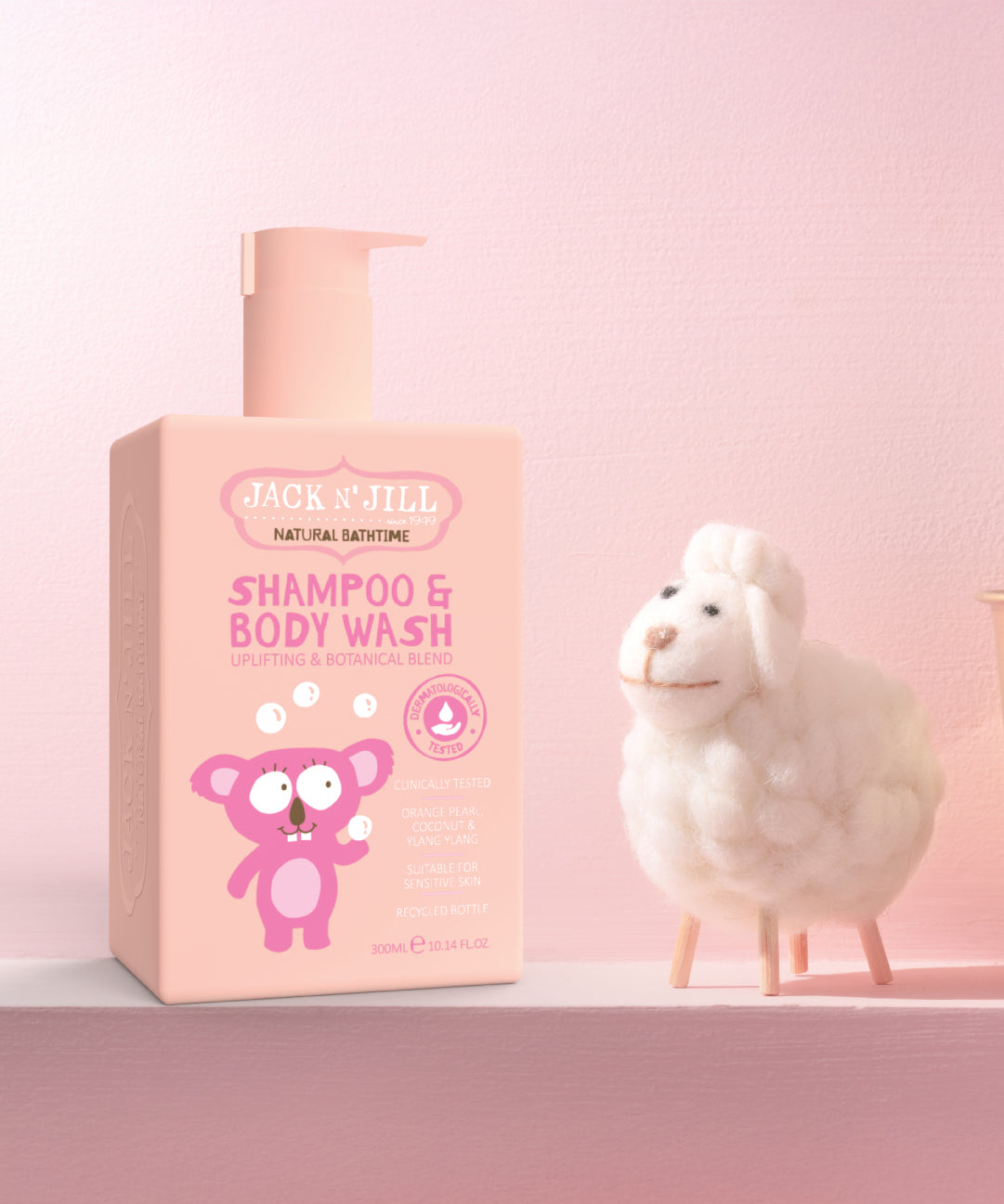 Jack N' Jill Shampoo & Body Wash in a 300ml pump bottle next to a felt sheep figure. 