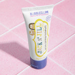 The Jack N Jill kids natural toothpaste in a bubblegum flavour, on pale pink tiles.