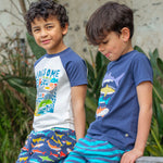 A close up of the Jawsome print of the Frugi Reid Raglan T-Shirt - Jawsome. A colourful t-shirt made from GOTS Organic cotton  with a white body with sea-life animal print