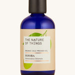 Organic Jojoba carrier oil in a blue glass bottle.