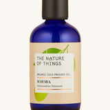 Organic Jojoba carrier oil in a blue glass bottle.