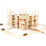 Just blocks handmade wooden building blocks stacked into a carpark shape on a white background