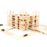 Just blocks handmade wooden building blocks stacked into a carpark shape on a white background