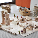 Just Blocks plastic-free wooden blocks stacked in a town scene on a grey carpet