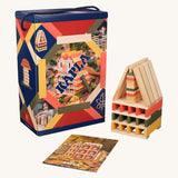 The Kapla 200 Autumn coloured building planks box, next to a small sculpture and an inspiration leaflet.