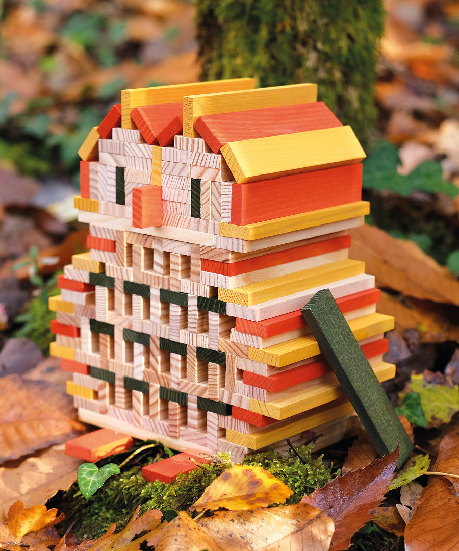 An owl sculpture, built from the Kapla 200 Autumn coloured wooden plank building block toys.