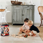 Children playing with the Kapla 200 Autumn coloured wooden plank building block toys.
