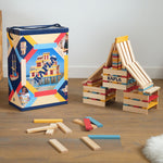 KAPLA Wooden Building Blocks 200 Box in Summer colours. A build can be seen by the side of the box with a few blocks on the floor. 