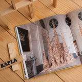 The Kapla Best Of artist collector's book, opened to show a page with a picture of a wooden Kapla sculpture.