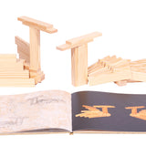 Wooden swan models next to the Kapla easy animals art book on a white background