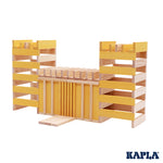 Kapla plastic-free wooden stacking blocks built up in a fort shape on a white background