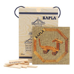Kapla plastic-free wooden building blocks set with a beige guide book laid out on a white background