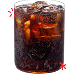 Glass of Karma Cola served over ice, showing the deep colour and natural fizz of this organic Fairtrade cola made with real kola nuts.