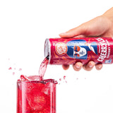 Karma Drinks Cherry Lee organic cherry soda being poured from the can into a glass of ice, highlighting the vibrant red colour and Fairtrade branding.