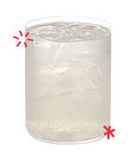 Karma Drinks Tropikool organic mango & passionfruit soda, in a glass with ice. 