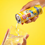 Karma Drinks Tropikool organic mango & passionfruit soda, poured into a glass with ice. 