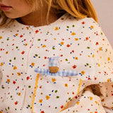 The doll from the Käthe Kruse soft toy baby with a blue check sleeping bag in a child's pocket. 