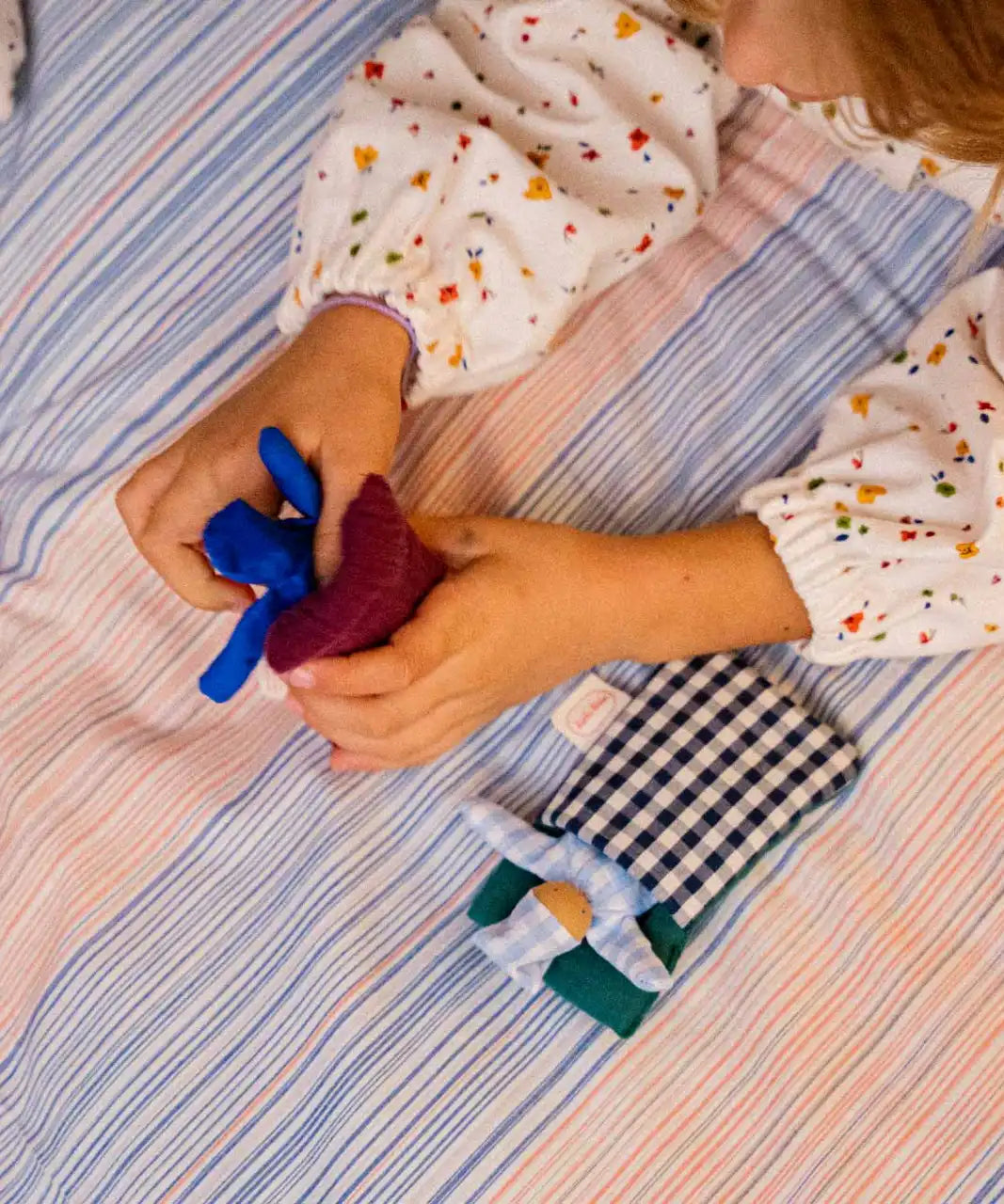 Käthe Kruse soft toy baby with a blue check sleeping bag. 