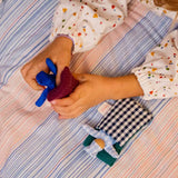 Käthe Kruse soft toy baby with a blue check sleeping bag. 