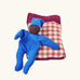 Kathe Kruse tiny organic cotton Waldorf baby doll with a gingham sleeping bag.