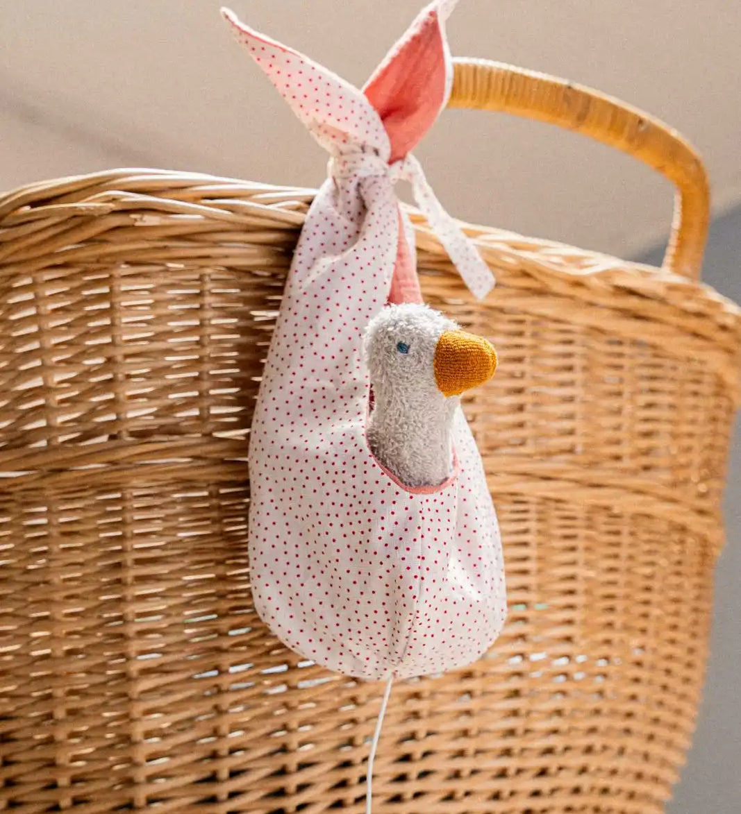 Käthe Kruse white duckling nest Animal music box soft toy. Small duckling soft toy in a white red spotted material nest.