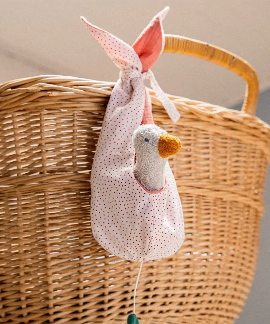 Käthe Kruse white duckling nest Animal music box soft toy. Small duckling soft toy in a white red spotted material nest.