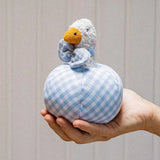 Käthe Kruse Ebba duck soft toy rattle and ball. Small duck wearing a blue and white check bowtie that is placed inside a slot in a matching ball. 
