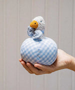 Käthe Kruse Ebba duck soft toy rattle and ball. Small duck wearing a blue and white check bowtie that is placed inside a slot in a matching ball. 