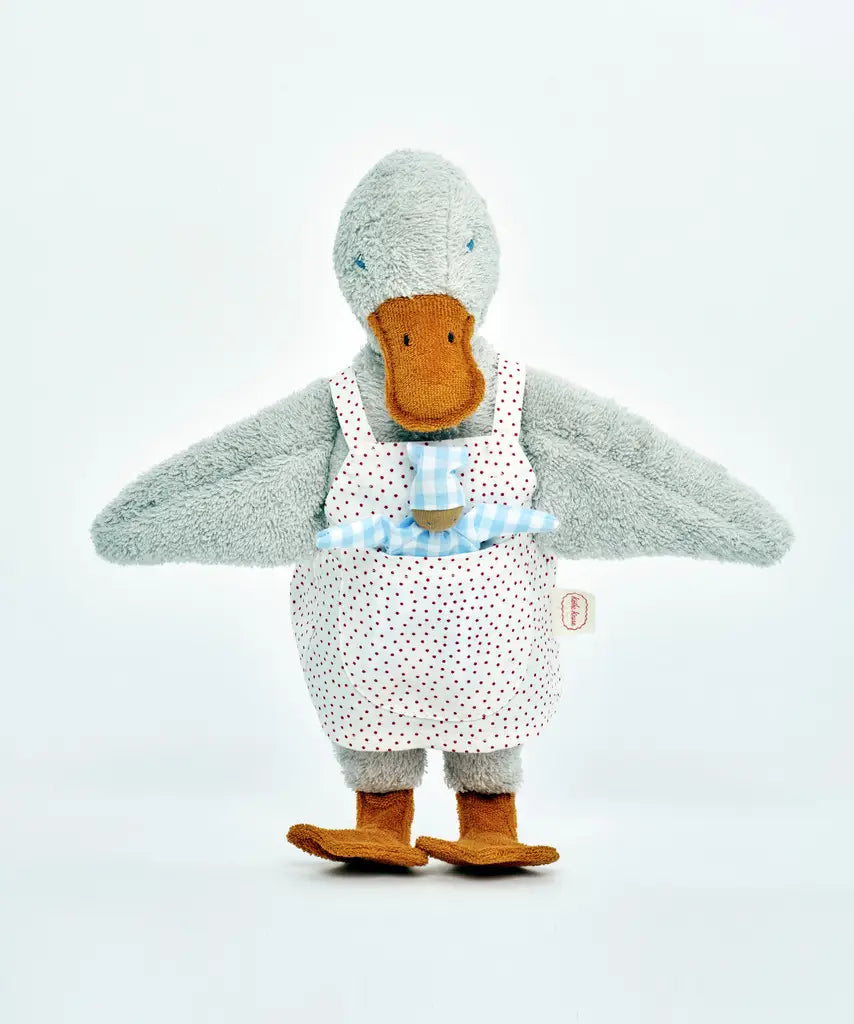 Käthe Kruse Eva duck standing soft toy wearing a white apron with red dots  showing a blue waldorf doll in apron pocket