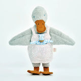 Käthe Kruse Eva duck standing soft toy wearing a white apron with red dots  showing a blue waldorf doll in apron pocket