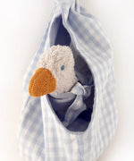 A white duckling soft toy sitting inside a blue gingham fabric nest from the Kathe Kruse animal music box set