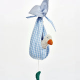 Small white duckling toy sitting inside blue ginham fabric nest from the Kathe Kruse animal music box set