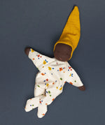 Käthe Kruse handmade Waldorf Doll Nini Sunshine with the legs crossed.