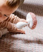 Käthe Kruse baby pilz grabbing toy, a red and white gingham topped toadstool shaped soft toy. 