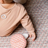  Käthe Kruse baby pilz grabbing toy, a red and white gingham topped toadstool shaped soft toy. View of top of mushroom.