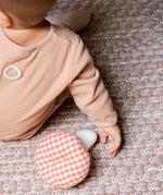  Käthe Kruse baby pilz grabbing toy, a red and white gingham topped toadstool shaped soft toy. View of top of mushroom.