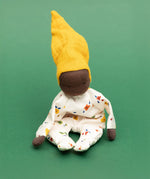 Käthe Kruse Waldorf Doll Nini Sunshine placed in a sitting position. 