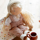 Käthe Kruse Waldorf doll Hannah in a seated position. Handmade cotton doll filled with sheep's wool. 