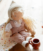 Käthe Kruse Waldorf doll Hannah in a seated position. Handmade cotton doll filled with sheep's wool. 