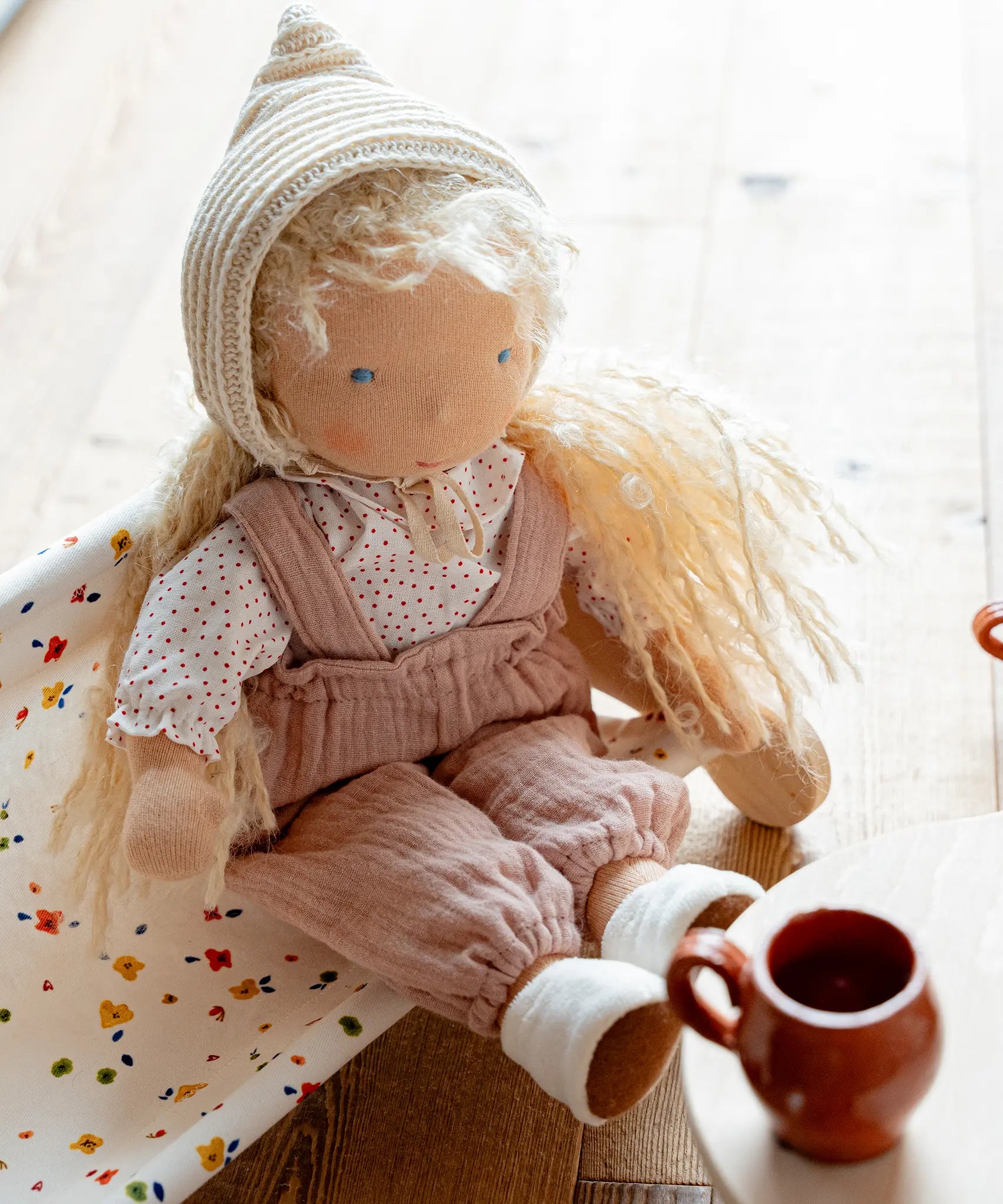 Käthe Kruse Waldorf doll Hannah in a seated position. Handmade cotton doll filled with sheep's wool. 