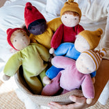 Adult carrying a basket full of Kathe Kruse nana waldorf dolls.