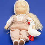 Käthe Kruse Waldorf doll Hannah in a seated position with a white felt goose.