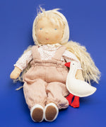 Käthe Kruse Waldorf doll Hannah in a seated position with a white felt goose.