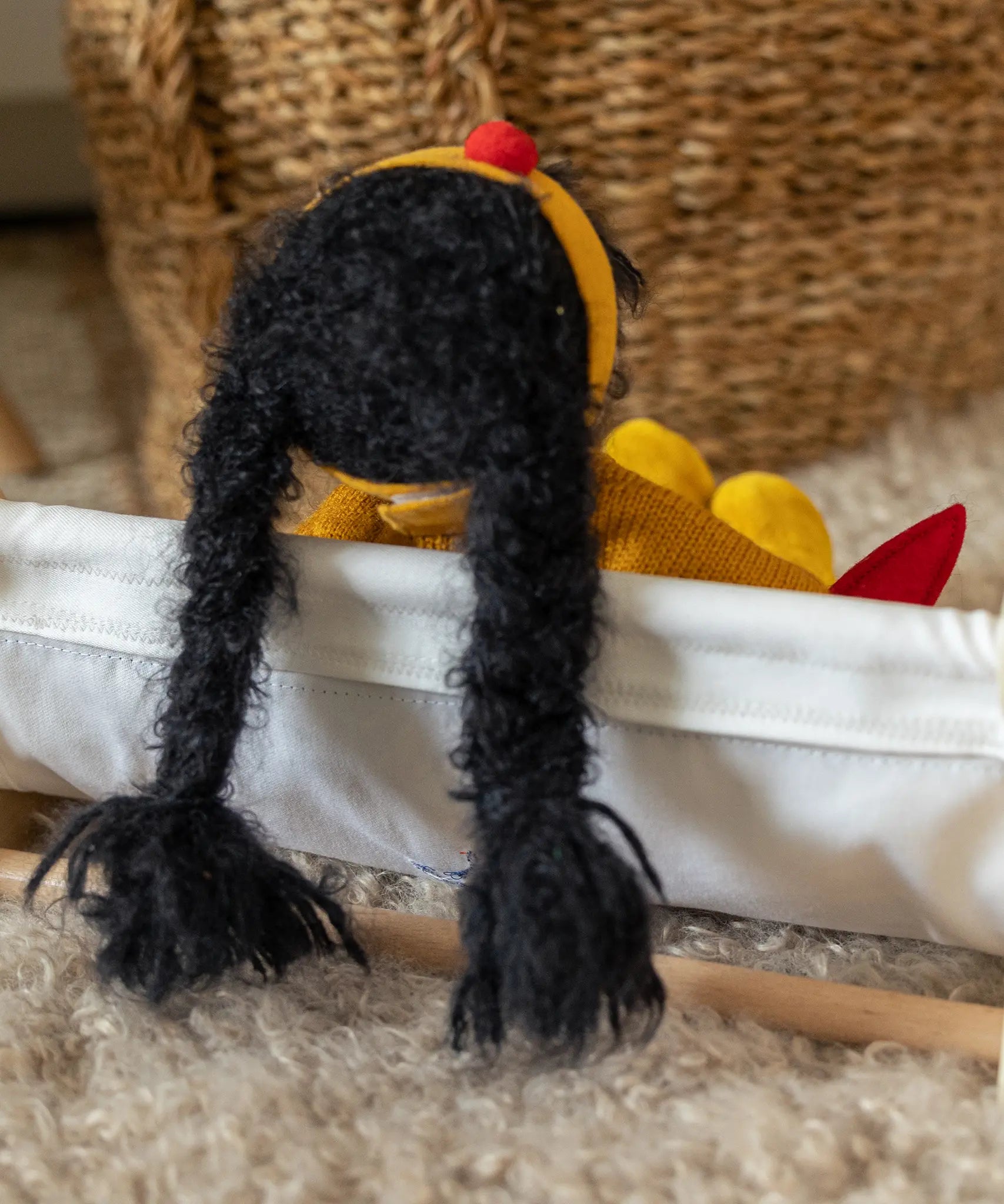 Käthe Kruse Waldorf Doll Kiki black hair, view of back with two long plaits. 