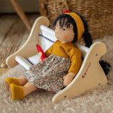 Käthe Kruse Waldorf Doll Kiki in a seated position. Handmade toy made with cotton and filled with natural sheep's wool.