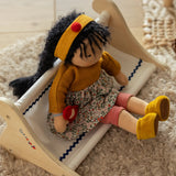 Käthe Kruse Waldorf Doll Kiki in a seated position. handmade doll using cotton and filled with wool. 