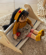Käthe Kruse Waldorf Doll Kiki in a seated position. handmade doll using cotton and filled with wool. 