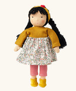 Käthe Kruse Waldorf Doll Kiki, white skin, black hair, ocre yellow headband, knitted jumper and boots, floral print skirt and red and white striped leggings.