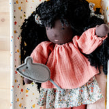 Käthe Kruse Waldorf Doll Nia placed in a doll's crib with small grey felt mouse that comes with it. 
